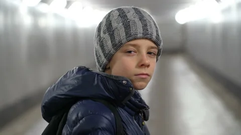 Portrait of alone confident boy in hat and jacket in underground covered walkway Stock Footage 168191625