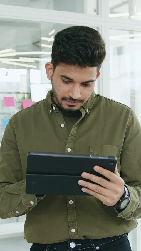 Portrait of american man looking at camera during using digital tablet at modern Stock Footage 331141549