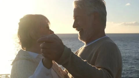 Portrait and close up of two happy in love seniors dancing smiling with the sun  Stock Footage 151333337