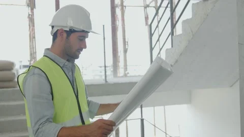 Portrait and lose up man engineer looking camera holding blueprint Stock Footage 150564114