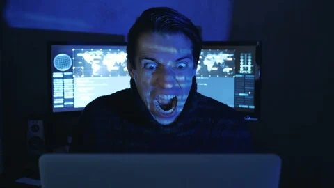 Portrait of Angry Hacker Programmer screams and shows aggression while working Video stock 100811705