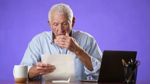 Portrait of angry stressed elderly man 70s, opening envelope reading bad news in Stock Footage 213283761