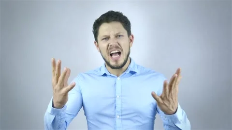 Portrait Of Angry Young Man Shouting Over Grey Background 動画素材 41795403