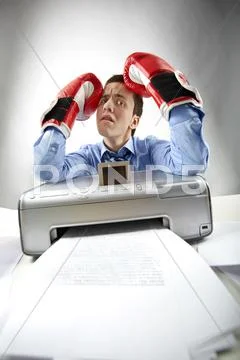 Portrait of annoyed businessman holding printed papers Stock Photos