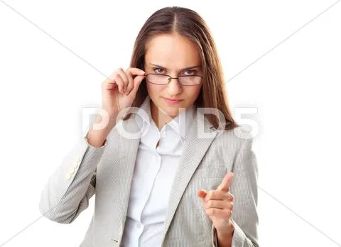 Portrait of annoyed businesswoman looking at camera with her forefinger raised Stock Photos
