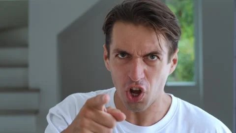 Portrait of annoyed man looking at the camera with an angry look on background Stock Footage 249570264