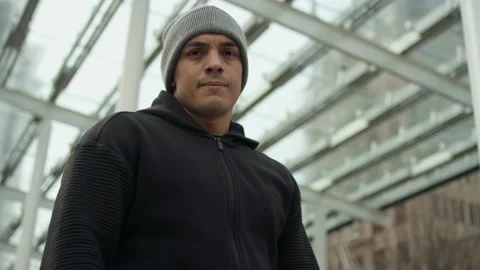 Portrait approaching a fit Latino athlete on a cold morning Video stock 153340887