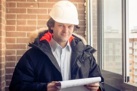 Portrait of an architect builder studying layout plan of the rooms, engineer Stock Photos