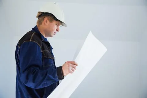 Portrait of an architect builder studying layout plan of the rooms Fotos de archivo