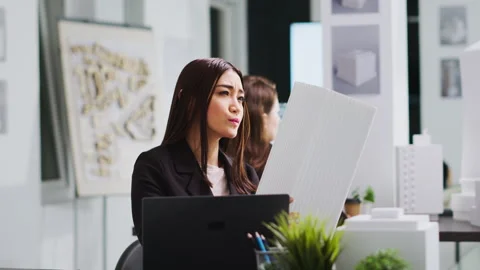 Portrait of architect studying 3d building model for measurements Vídeos de archivo 262998172