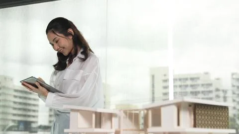 Portrait of architect using tablet while looking house model. Manipulator. 스톡 사진