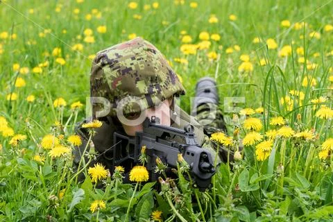 Portrait of armed woman with camouflage. Young female soldier observe with fi Stock Photos