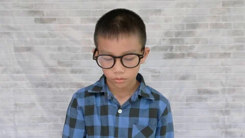 Portrait of Asian boy crying  on brick background Stock Footage 116411201