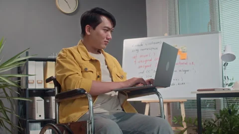 Portrait of Asian Coder in Wheelchair Working on Wireless Laptop Stock Footage 265073668