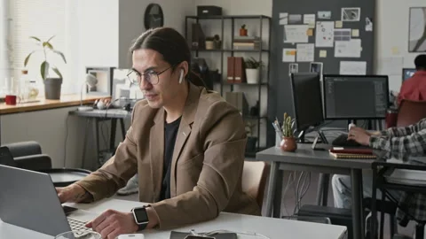 Portrait of Asian Male Programmer Working on Laptop in Tech Startup Stock-Footage 336712091