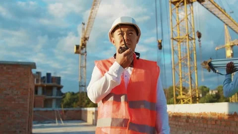 Portrait asian man builder engineer worker in hard hat with use a walkie-talkie Stock Footage 139341687