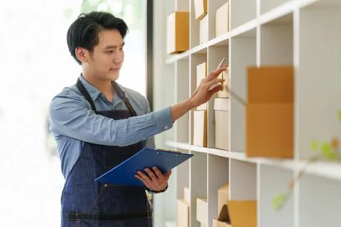 A portrait of Asian man, e-commerce employee freelance with parcel box for 写真素材