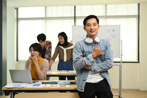 Portrait of asian man web developer standing in creative office with his Stock Photos