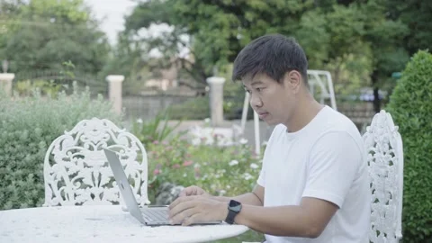 Portrait of Asian man working on computer at garden home Stock Footage 154078778