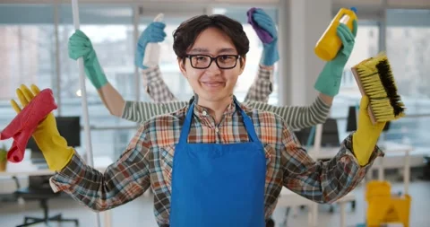 Portrait of asian multi-armed man janitor holding cleaning equipment and smiling Stock Footage 148208119