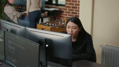 Portrait of asian programer focused on writing code encounters unexpected Stock Footage 168235586