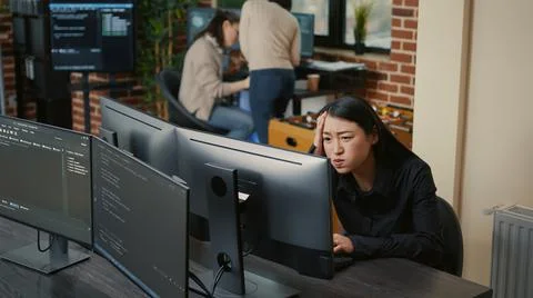 Portrait of asian programer focused on writing code encounters unexpected Foto stock