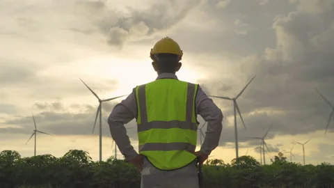 Portrait of Asian windmill engineer man, worker working on site at wind turbi Video stock 152699858