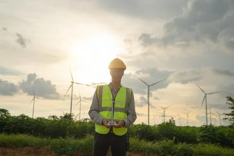 Portrait of Asian windmill engineer man, worker working, holding a model on s 스톡 사진