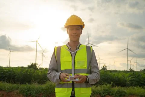Portrait of Asian windmill engineer man, worker working, holding a model on s Foto stock