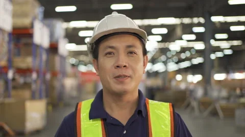 Portrait of Asian worker working in large warehouse retail store industry. Ra Stock Footage 222865989