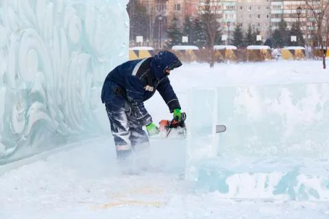 Portrait of an assembler with a chainsaw in his hands 스톡 사진