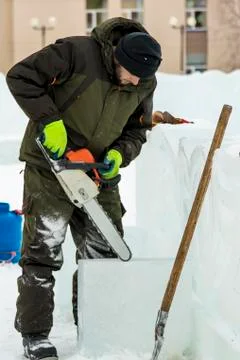 Portrait of an assembler with a chainsaw in his hands 스톡 사진