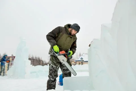 Portrait of an assembler with a chainsaw in his hands 스톡 사진