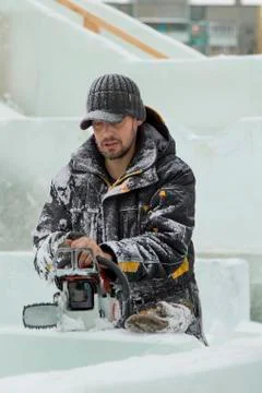 Portrait of an assembler with a chainsaw in his hands 스톡 사진