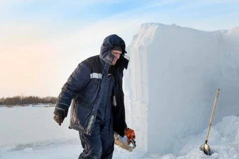 Portrait of an assembler with a chainsaw in his hands 스톡 사진