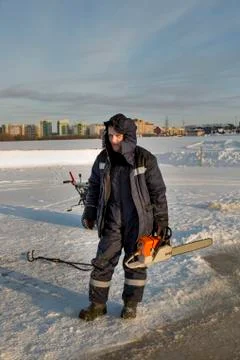 Portrait of an assembler with a chainsaw in his hands 스톡 사진