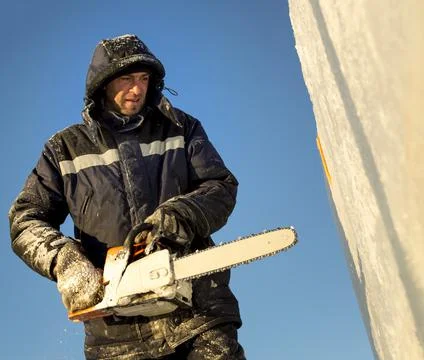 Portrait of an assembler with a chainsaw in his hands 스톡 사진
