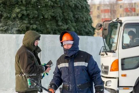 Portrait of an assembler in an orange helmet 스톡 사진