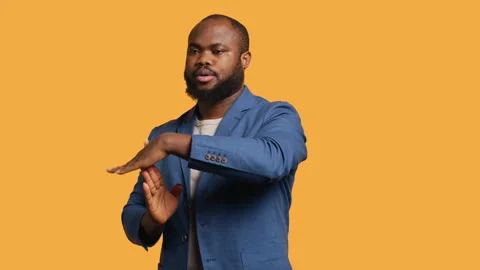 Portrait of assertive man asking for timeout, studio background Stock Footage 272545843