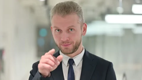 Portrait of Assertive Young Businessman Pointing with Finger and Inviting Stock Footage 138926274