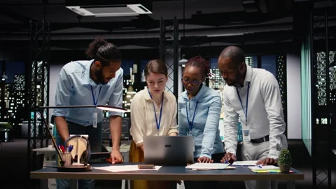 Portrait of associates team collaborating in office environment at night Stock Footage 334039870