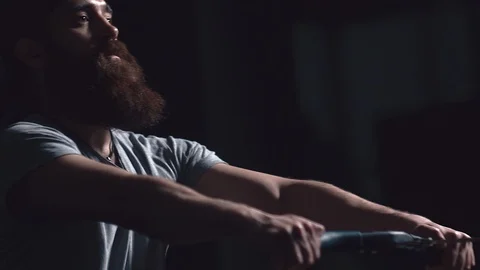 Portrait of an athlete with a beard is engaged in a rowing machine 库存影片 90642763