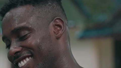 Portrait of athletic sweated guy resting after jumping rope, Smiling African Stock Footage 141734327