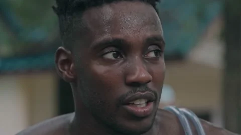 Portrait of athletic sweated guy resting after jumping rope, Smiling African Stock Footage 141748160