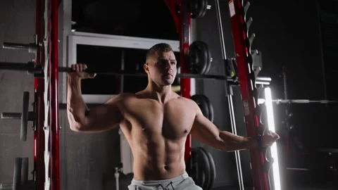 Portrait of an athletic young man exercising in the gym doing strength exercises Stock Footage 160029547