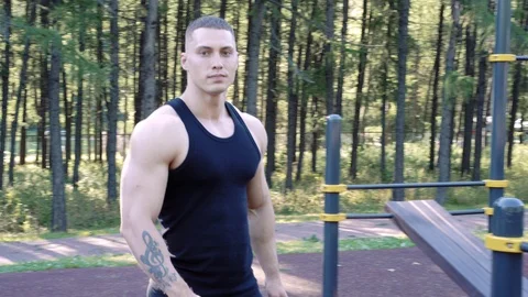Portrait of athletic young man posing in front of camera outdoors Stock Footage 112084986