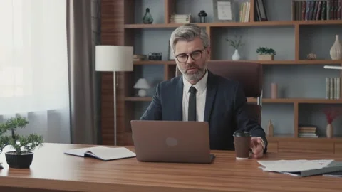 Portrait of attractive businessman open using a laptop drinking coffee looking Vídeos de archivo 220153602