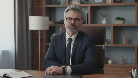 Portrait of attractive businessman using and closing laptop looking at camera Vídeos de archivo 220190942