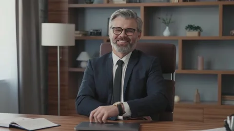 Portrait of attractive businessman using and closing laptop looking at camera Vídeos de archivo 220195019