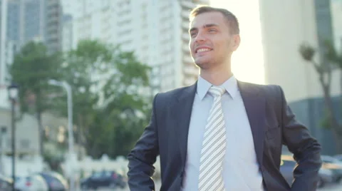 Portrait of the attractive confident businessman standing before office building Stock Footage